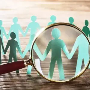 magnifying glass and paper dolls