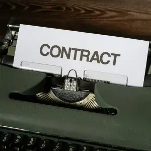 Typewriter with page that says contract on top