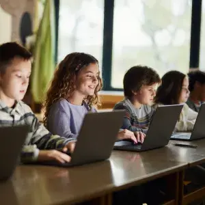 school children on laptops
