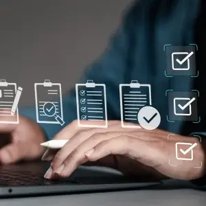 man typing on laptop with checkmarks